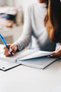 Accountant writing in notepad